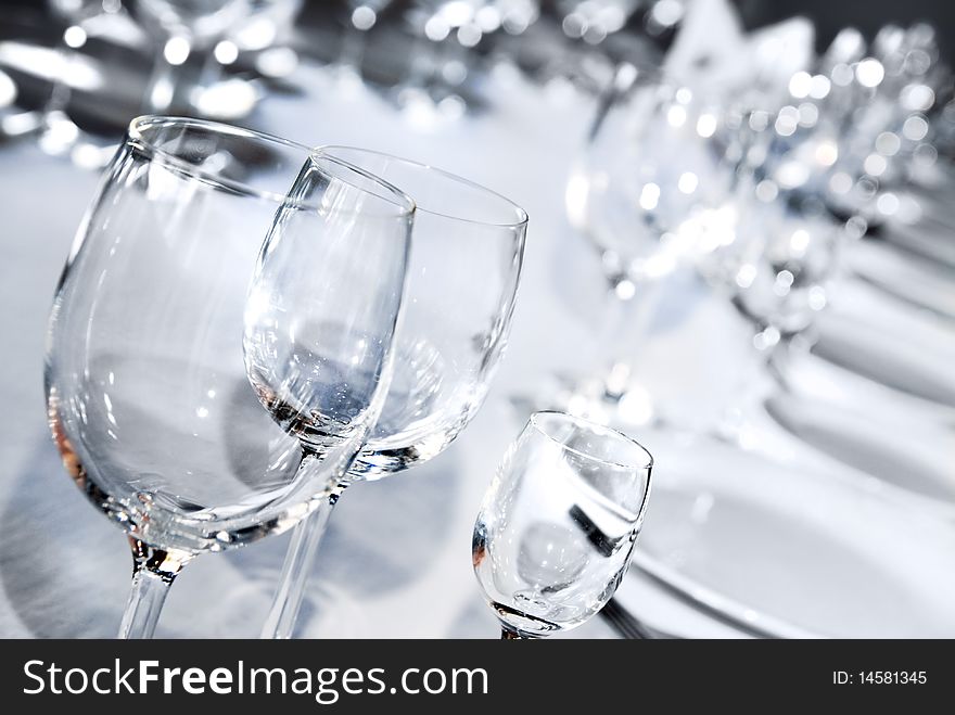 Glass goblets on white table