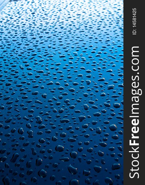 An interest texture is formed from puddles of water on the car bonnet lid, against natural light of the sun. An interest texture is formed from puddles of water on the car bonnet lid, against natural light of the sun