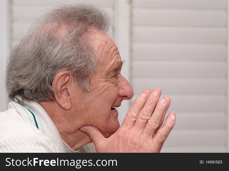 Smiling Elderly Man Resting His Head On Hands