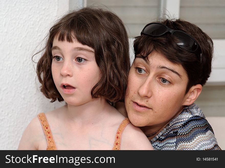 Mother And Little Daughter Watch TV In Great