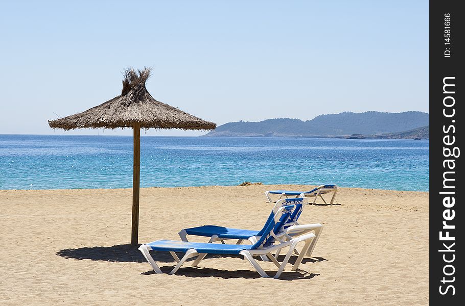 Sunshade and deck chair in the beach. Sunshade and deck chair in the beach