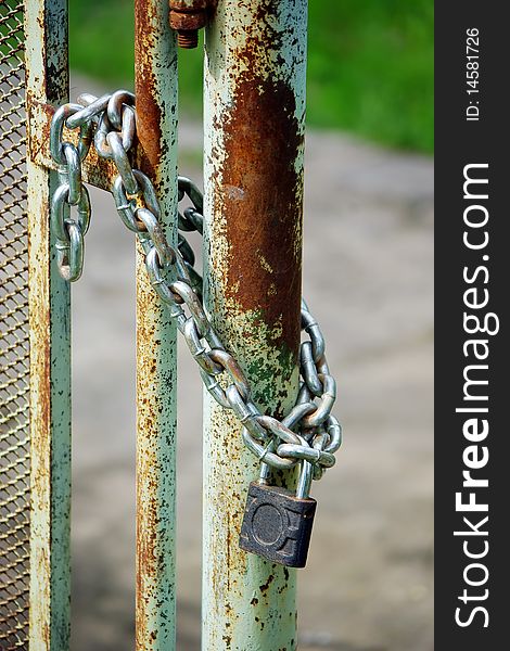 Old rusty gates closed wiyh chain and  padlock