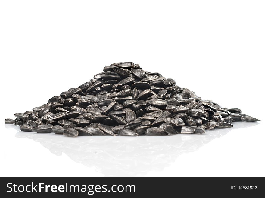Pile of black sunflower seeds isolated on a white background