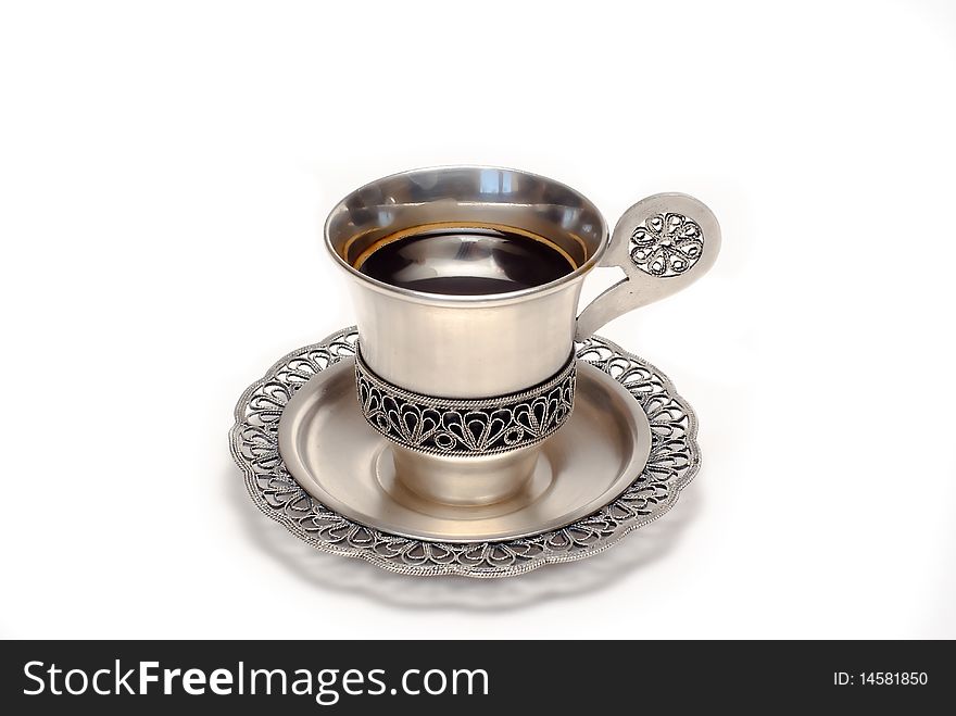Silver cup of coffee is on the white background. Silver cup of coffee is on the white background