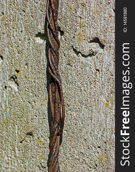 Old rusty rope of iron wires on concret wall background