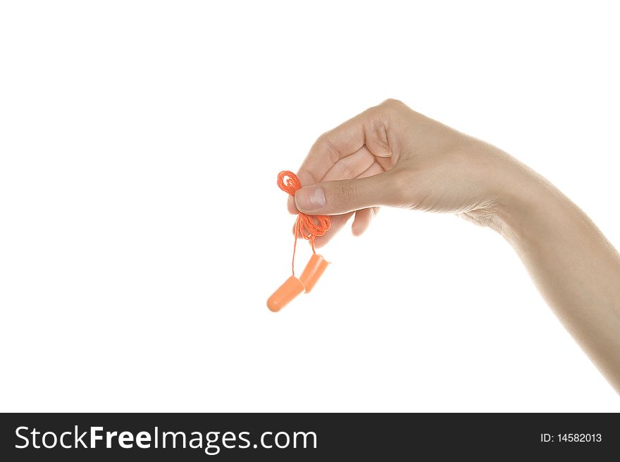 A pair of orange plastic ear plugs are in hand. Isolated on white background