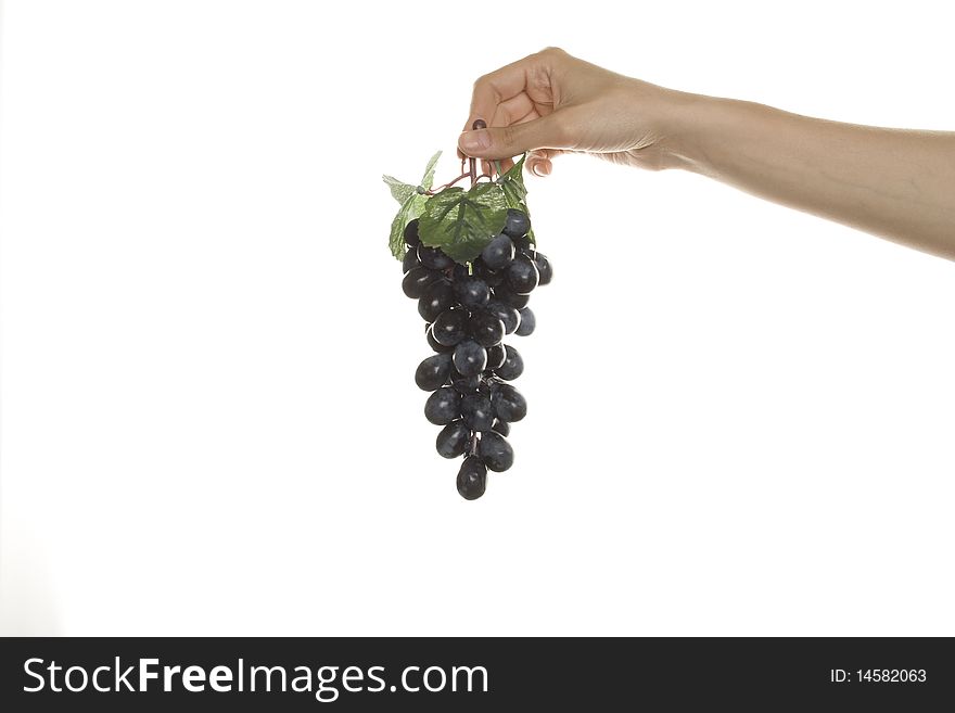 Artificial branch of grapes in his hand women. Artificial branch of grapes in his hand women