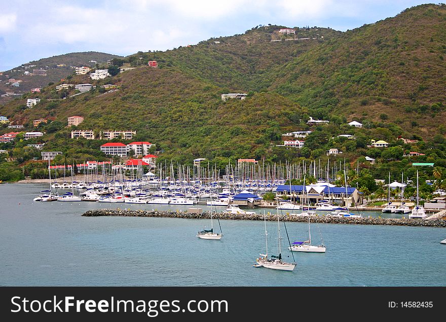 Sailboats crowded into a marina on the Caribbean island of Tortola, British Virgin Islands. Sailboats crowded into a marina on the Caribbean island of Tortola, British Virgin Islands