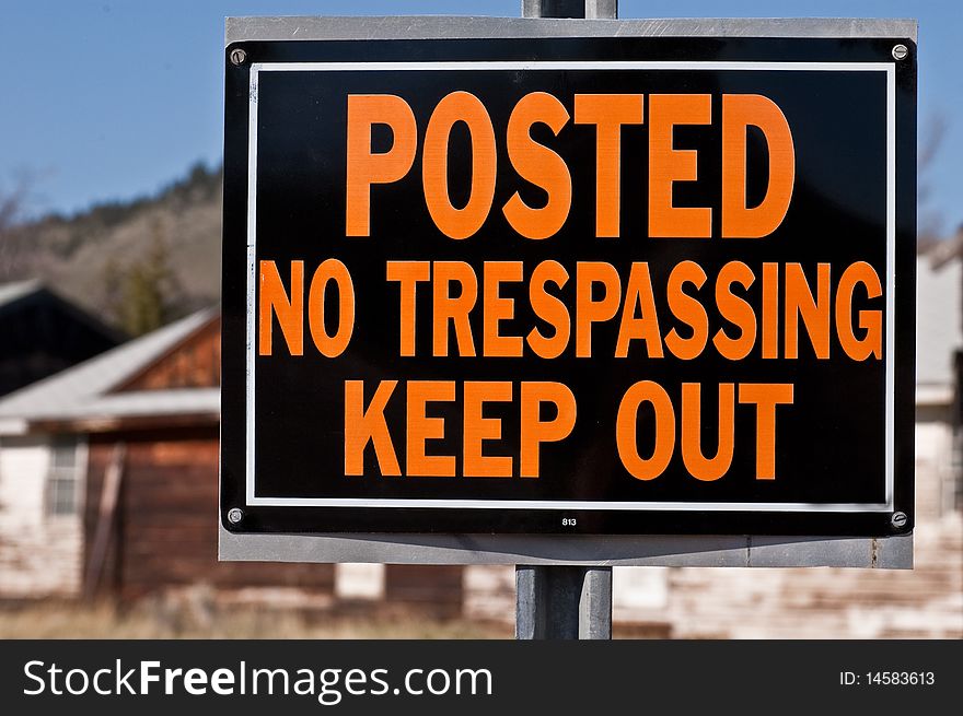 A cautionary sign indicating no trespassing. A cautionary sign indicating no trespassing
