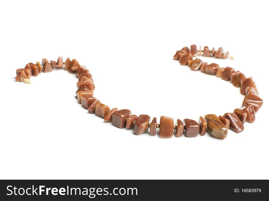 Brown agate necklace made from different pieces. Isolated on white. Brown agate necklace made from different pieces. Isolated on white
