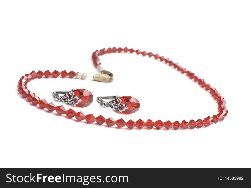 Red necklace and earrings isolated on white background. Red necklace and earrings isolated on white background