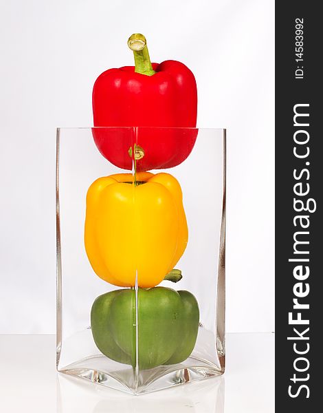 Fresh and delicious stoplight bell peppers in vase. Fresh and delicious stoplight bell peppers in vase