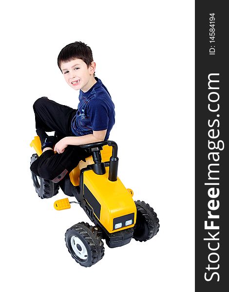 Small boy on the yellow tractor isolated on white background