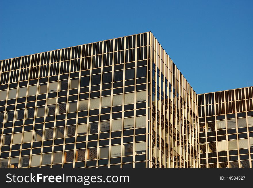 A modern office building with a blue sky