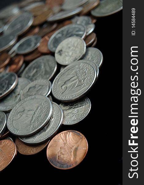 A whole bunch of American coins piled on top of one another to make this background. Shallow depth of field. A whole bunch of American coins piled on top of one another to make this background. Shallow depth of field.