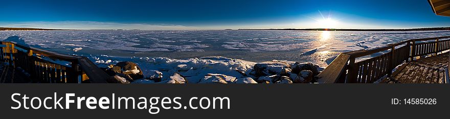 Panoramic view of sea gulf covered with ice