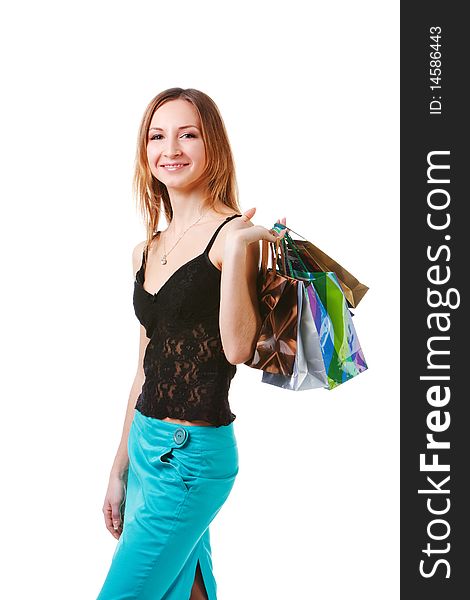 Picture of a charming young lady in blue skirt with packets after shopping on white background. Picture of a charming young lady in blue skirt with packets after shopping on white background.