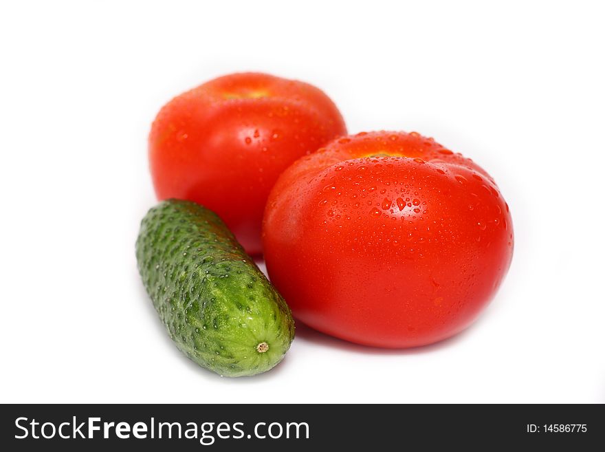 Red tomato and cucumber isolated on white background