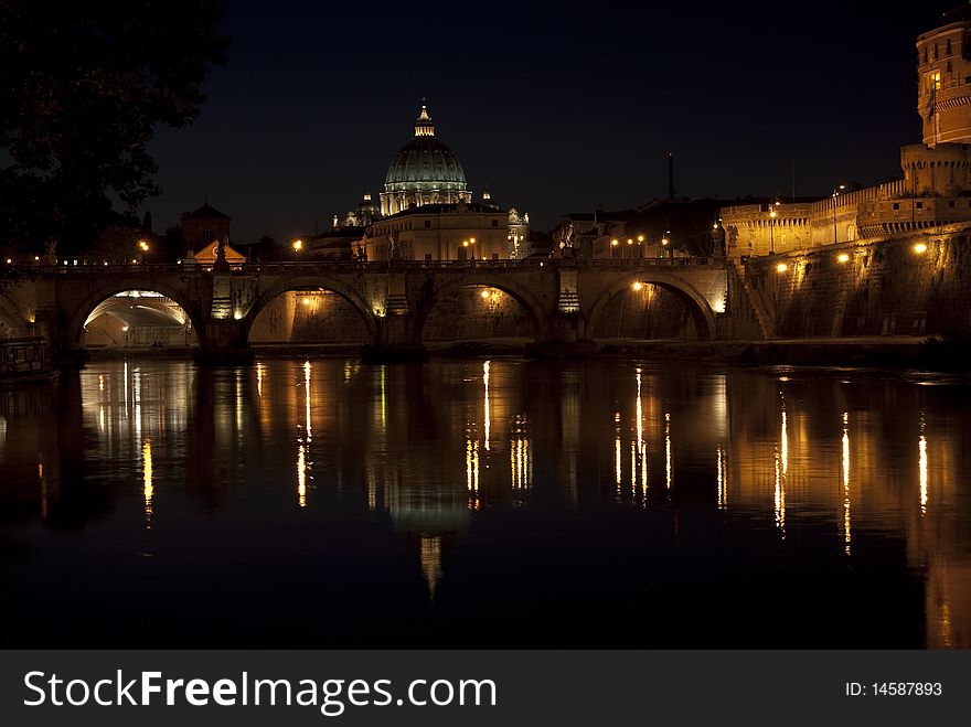 Rome. the tiber river by night with the dome of St. Peter