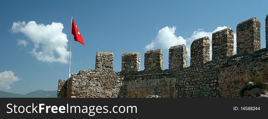 Alanya fortress detail and Turkey flag. Alanya fortress detail and Turkey flag