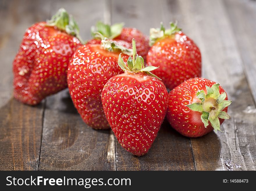 Heap of fresh strawberries on dark wooden table top. Heap of fresh strawberries on dark wooden table top