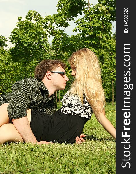 Young man and girl embracing outdoor summer time