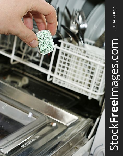 Placing soap in a dishwasher. Placing soap in a dishwasher