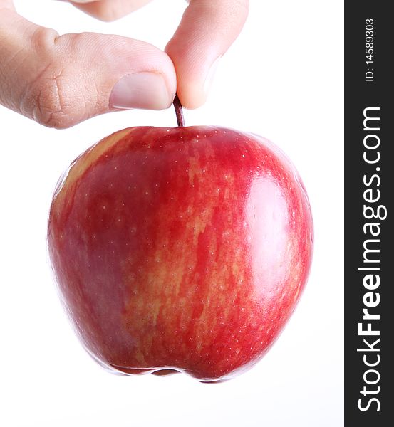 Red apple on man hand over white background. Concepts: Nutrition, Food, Health & Wellness. Red apple on man hand over white background. Concepts: Nutrition, Food, Health & Wellness
