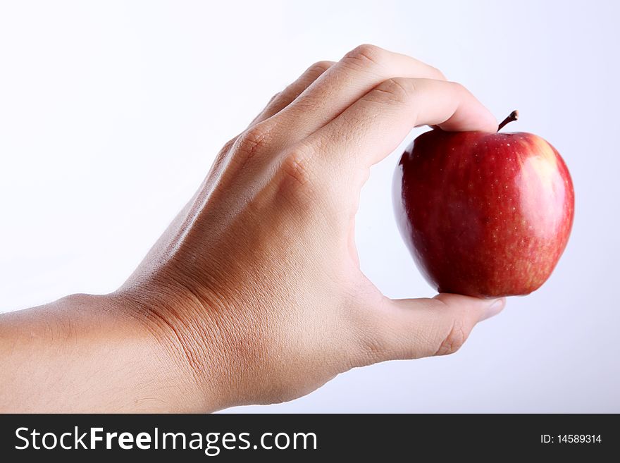 Red apple on hand over white background. Red apple on hand over white background