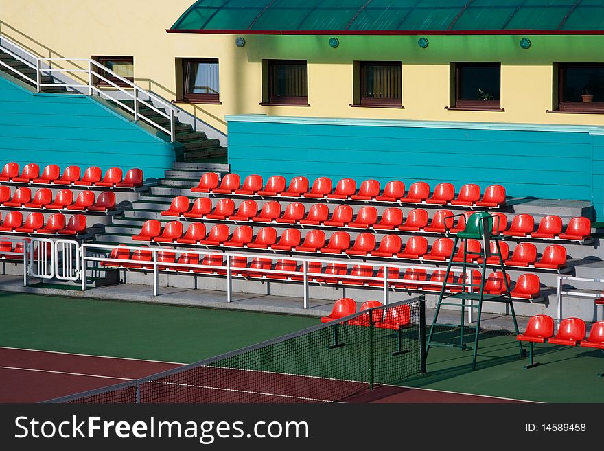 View of empty tennis arena red seats. View of empty tennis arena red seats