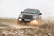 Off-road Car Driving Through A Puddle Stock Photos