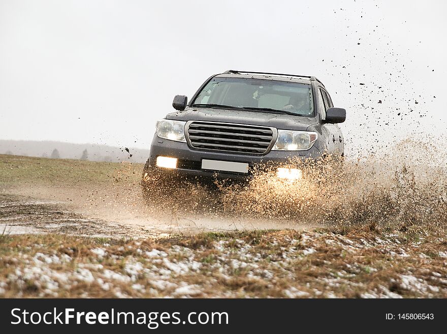 Off-road Car Driving Through A Puddle