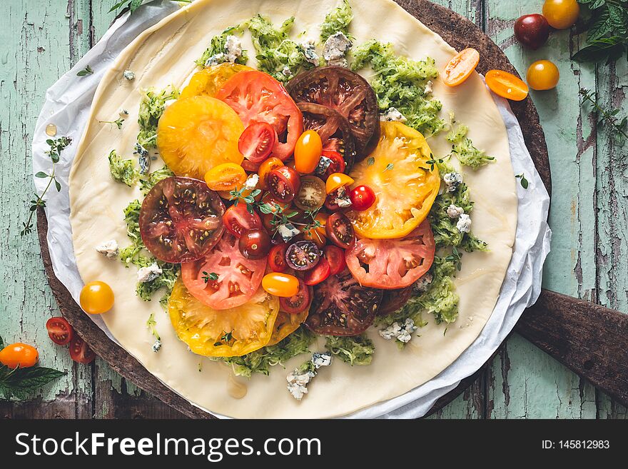 Heirloom Tomatoes Tart with Fresh Tomatoes and Cheese on wooden background