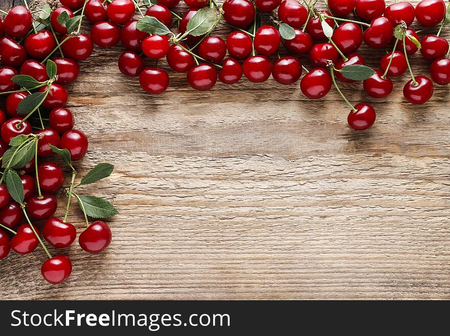 Cherries on wooden background, copy space