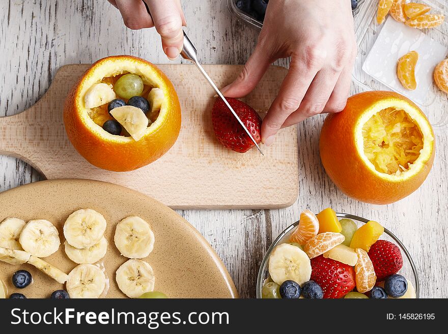 Orange filled with fruit salad. Healthy fruits