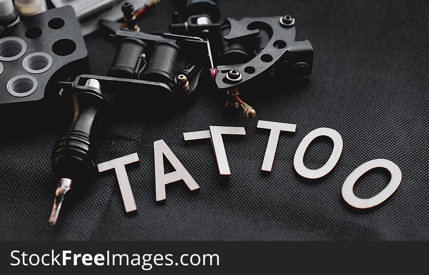 Tattoo accessories With inscription tattoo of wooden letters - black background