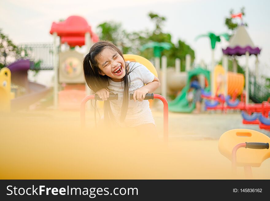 Child Playing having fun on playground .