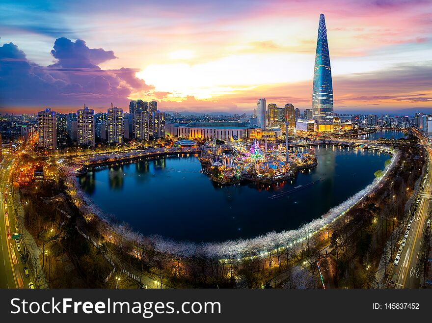 Sunset over cherry blossom park and tower background  in Seoul city, South Korea, this image can use for travel, night, cityscape, sakura, and holiday concept. Sunset over cherry blossom park and tower background  in Seoul city, South Korea, this image can use for travel, night, cityscape, sakura, and holiday concept