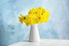 Bouquet Of Daffodils In Jug Against Color Background. Fresh Spring Flowers Stock Image