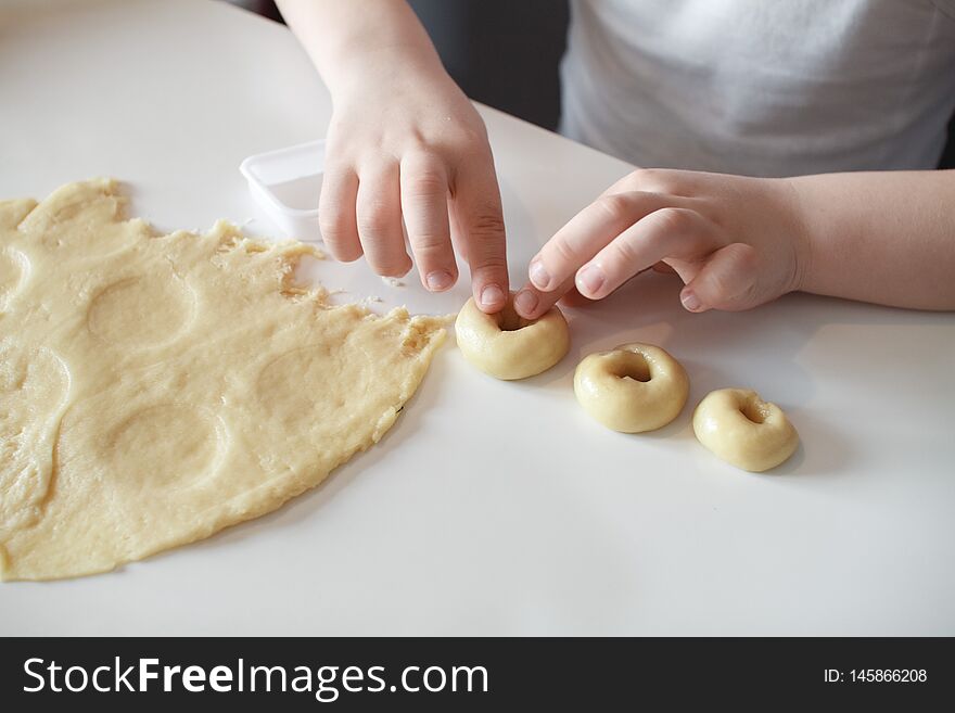 The Child Makes Cookie Molds On A White Table. Preparation Of Homemade Dessert. Close Up