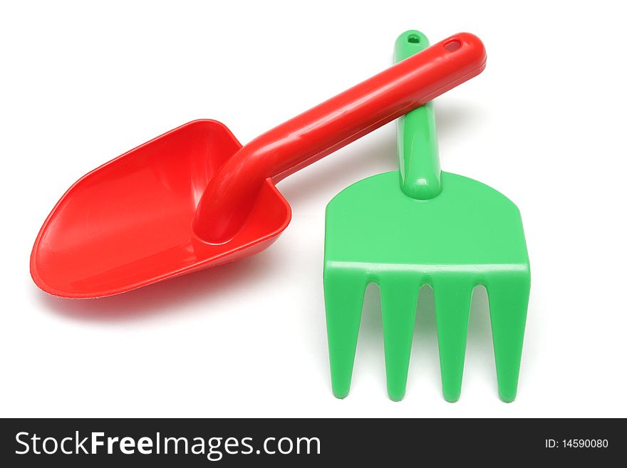 Red Shovel And Green Rake Isolated