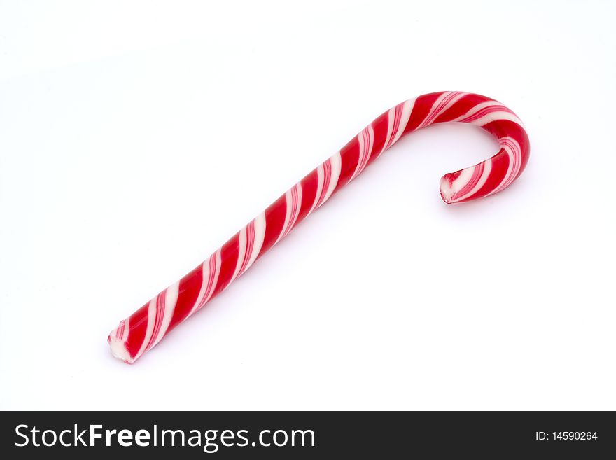 Pink stripy candy cane isolated on a white background. Pink stripy candy cane isolated on a white background