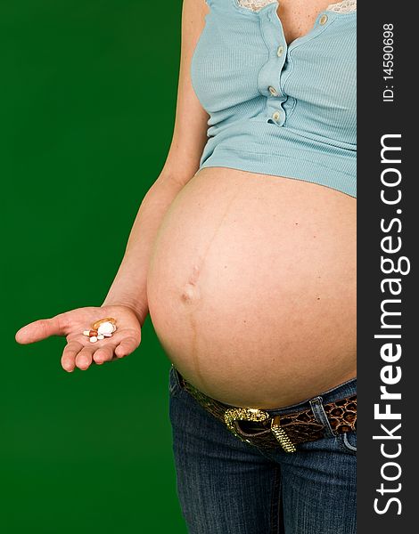Photo of pregnant woman and many pills in hand. Photo of pregnant woman and many pills in hand