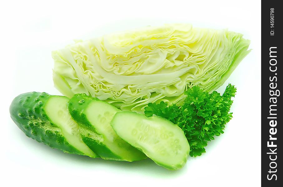 Vegetables and greens. Fresh cucumber with fragrant parsley on white background. Vegetables and greens. Fresh cucumber with fragrant parsley on white background
