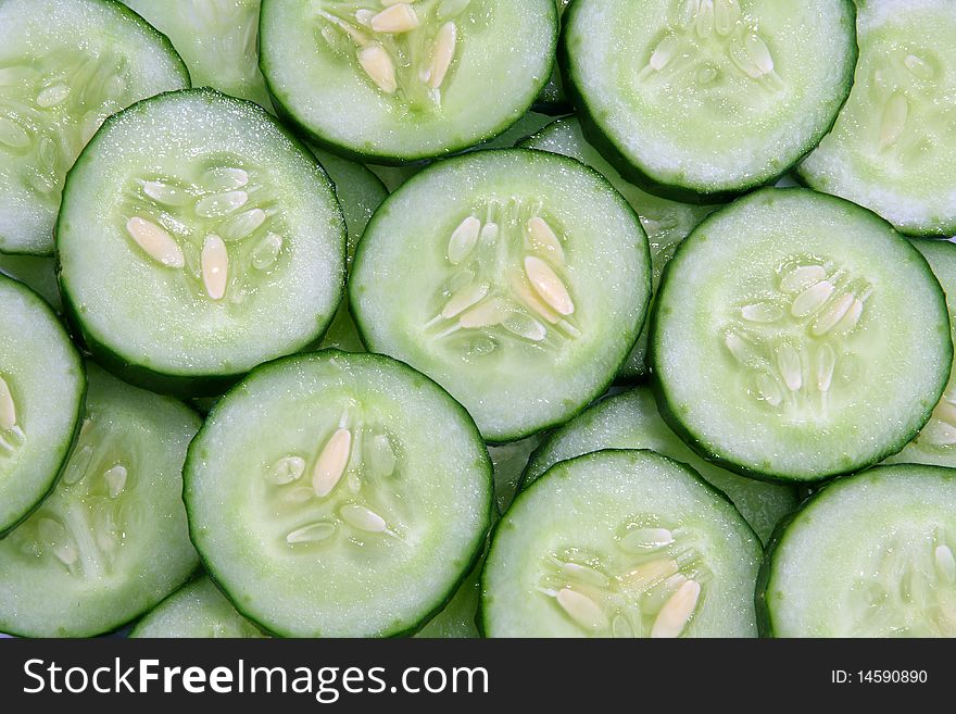 The slices of cucumbers background. The slices of cucumbers background