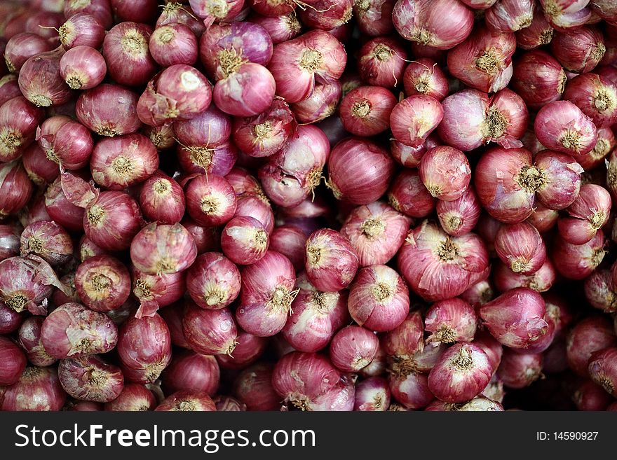 Red shallots on a market table