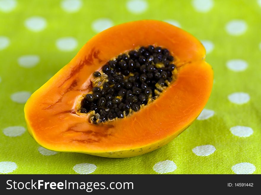 Cut Up Papaya Fruit On Green Background