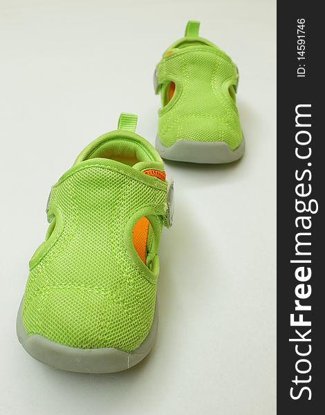A pair of green kid shoes,isolated in the white background. A pair of green kid shoes,isolated in the white background