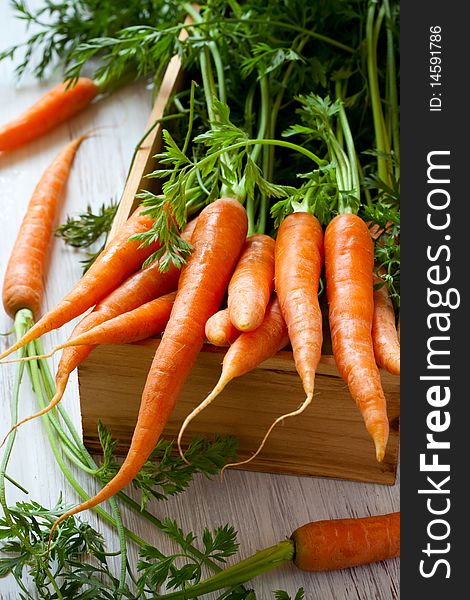 Fresh organic carrots in a wooden box