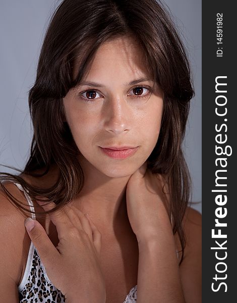 A soft portrait of a brown eyed, brown haired young woman looking into the camera. A soft portrait of a brown eyed, brown haired young woman looking into the camera